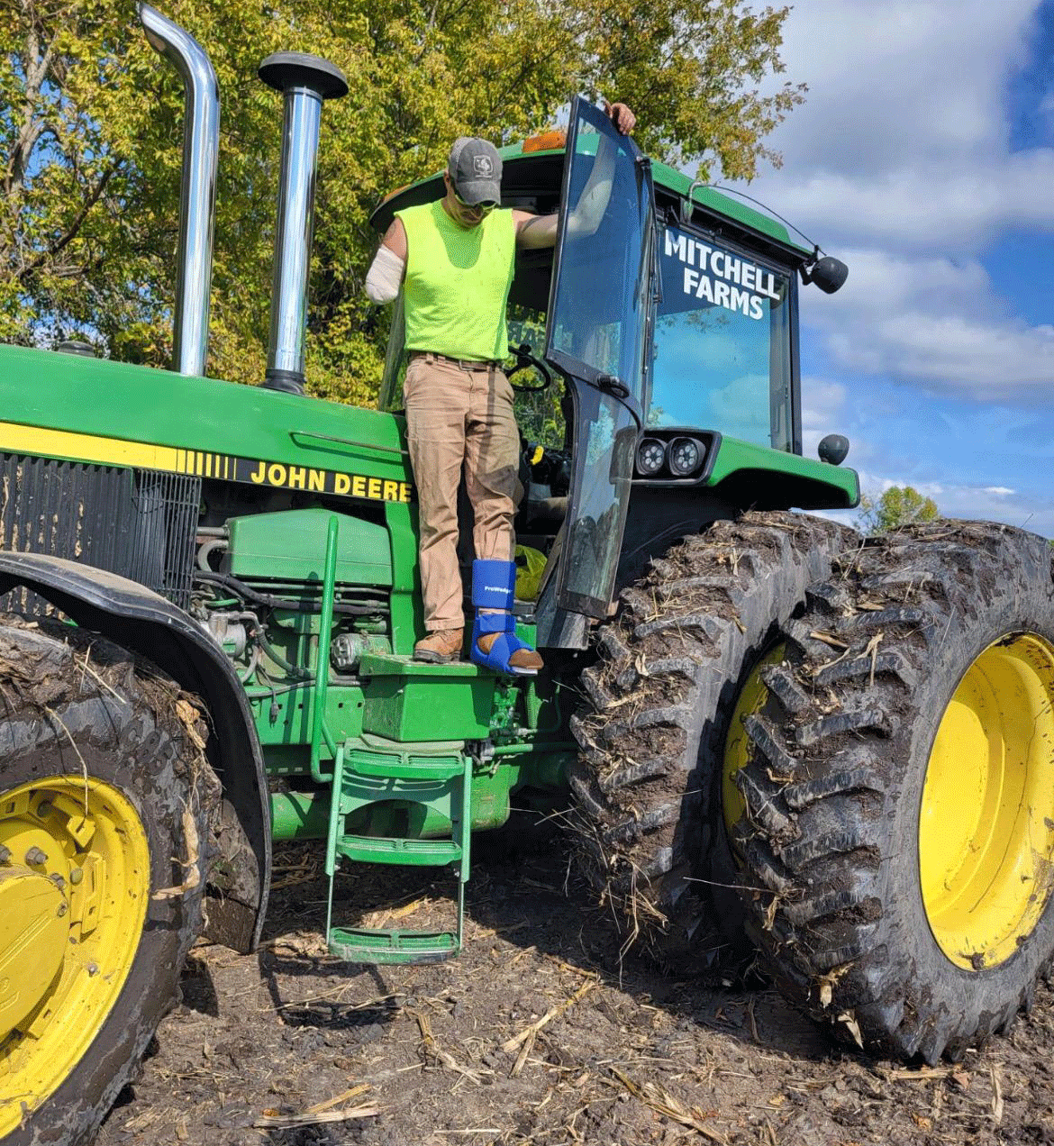 John Mitchell, who lost most of his right arm in a farm accident in September 2022, steps out of his family farm tractor.