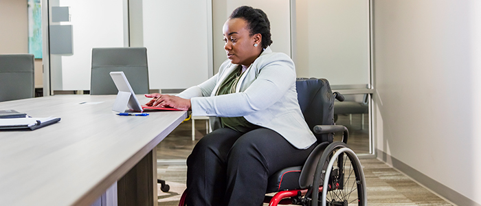 Person with wheelchair using a tablet