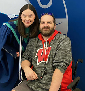 Jack Brunslik poses for a photo with his daughter, Sara, at her high school graduation ceremony in May 2024.