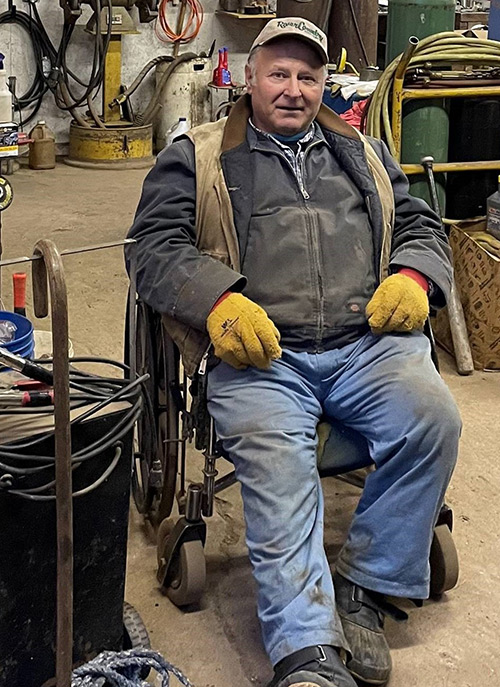 Cebery often uses a wheelchair while working in his garage.