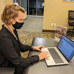 woman using computer in public library