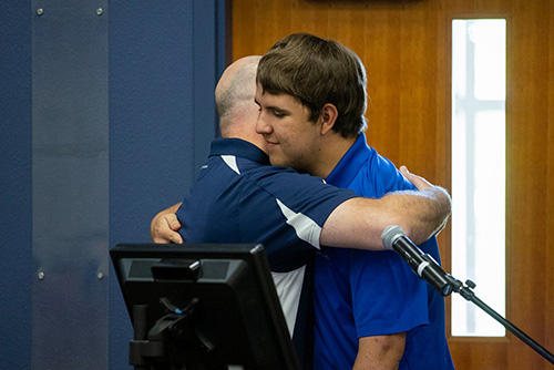 Project SEARCH graduate Paxton Tuescher embraces his dad, Kurt, following their presentation together at the UW-Platteville Project SEARCH graduation ceremony on Thursday, June 2.