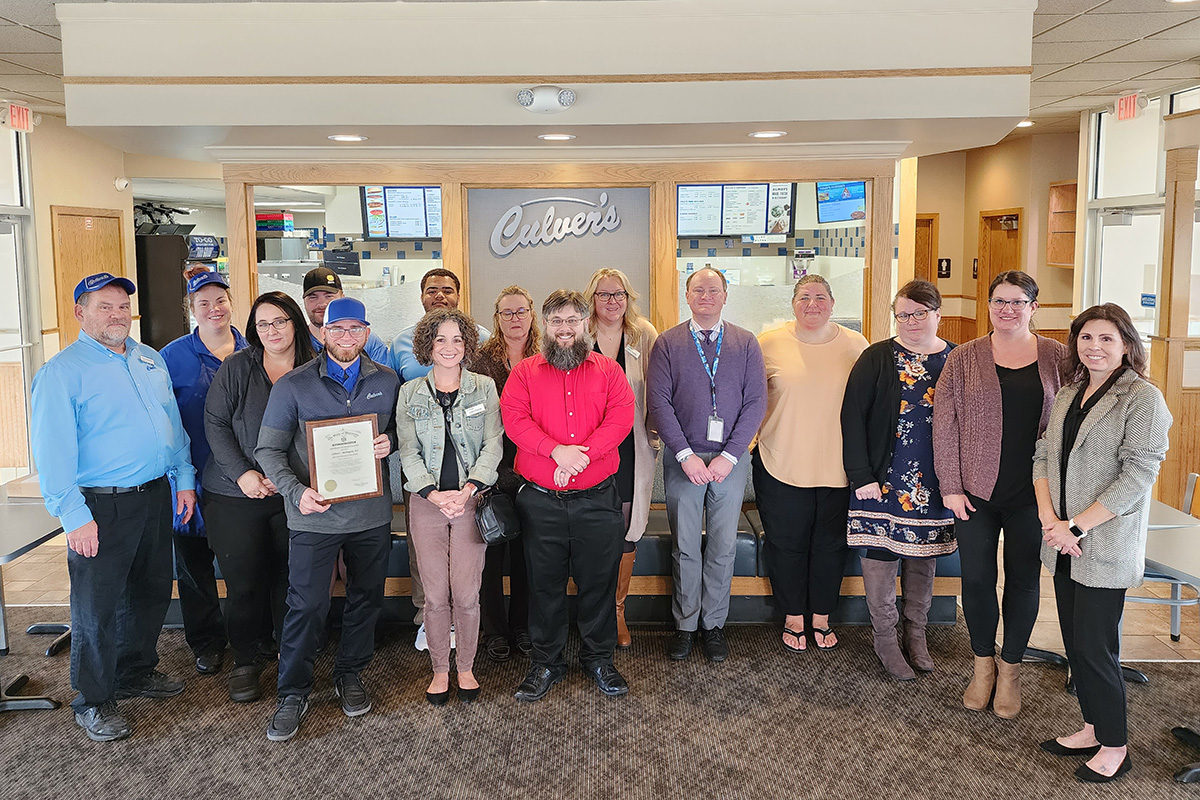 Franchise owner Tom Harbert (far left) stands with Culver's of Burlington's team members, local DVR leadership, and consumer service providers from Racine Opportunity Center. 