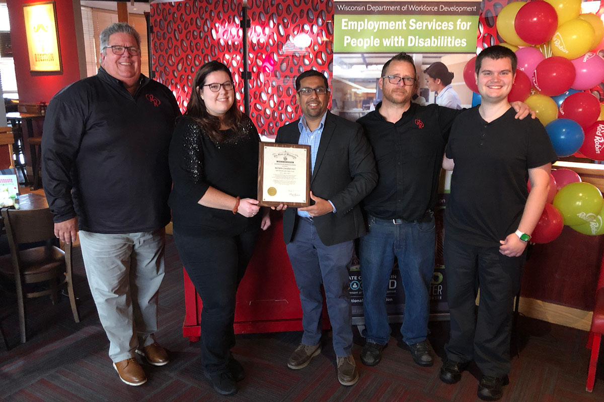 Red Robin Greenfield was presented with Gov. Tony Evers' Exemplary Employer Award on Tuesday, Oct. 24, during National Disability Employment Awareness Month. Pictured, from left, Market Partner Jake Sweeney, Assistant General Manager Alissa Jackson, DVR Business Services Consultant Sameer Bhaiji, General Manager Andy Smith, and Red Robin Team Member Alex Padd. 