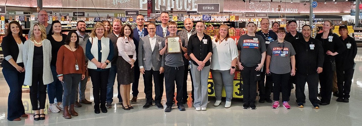DVR Consumer Joey Schultz (center) stands with Meijer's Exemplary Employer Award. Schultz is surrounded by Meijer corporate and regional representatives, local store staff, and local DVR and service provider staff from Aspiro and Beyond Possibilities. Manitowoc Mayor Justin Nickels and Schultz's grandparents were also in attendance.