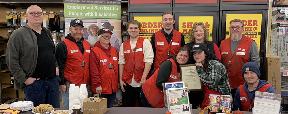 Team members and leadership from Tractor Supply Company in Viroqua proudly gather around their store's Exemplary Employer Award. 