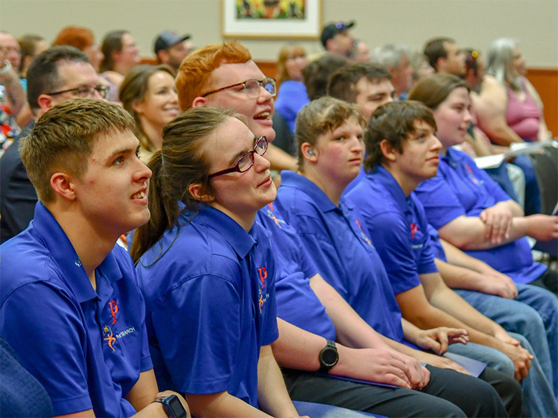 Project SEARCH graduates at UW-Platteville smile as they watch a slideshow